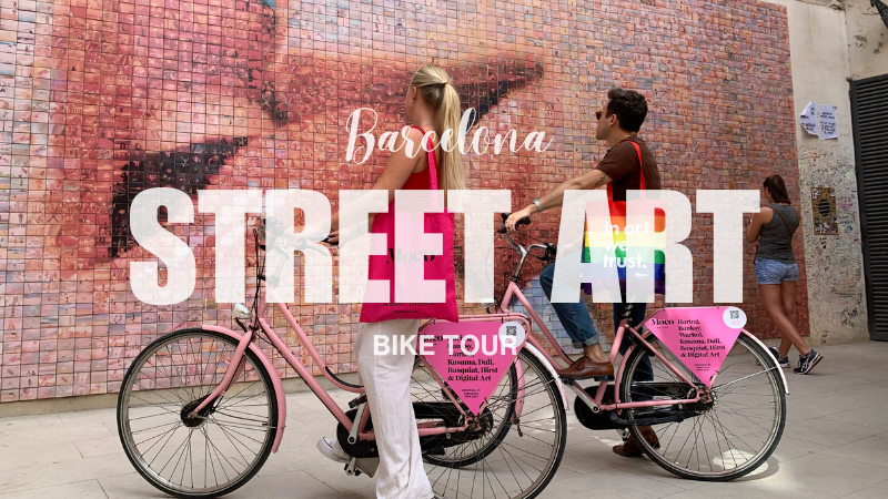 Enthusiastic A-Bike Rental & Tours Barcelona customers admire the vibrant Kiss mural during their engaging Street Art city bike tour.